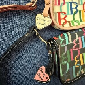 Two NWOT Dooney & Bourke east west wristlets.  One black, one ivory.